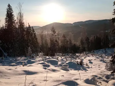 a snow covered mountain with the sun in the background at Bed and Breakfast Hadeland in Harestua