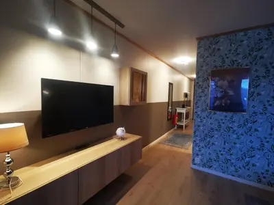 a living room with a large flat screen tv on a wall at Flåm Marina in Flåm