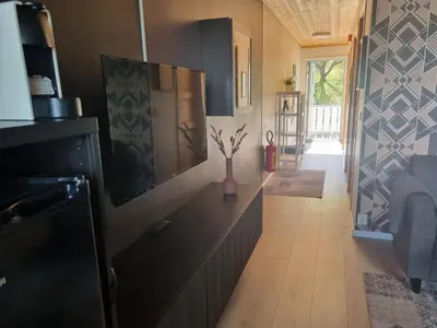 a kitchen with a television and a vase on a counter at Flåm Marina in Flåm