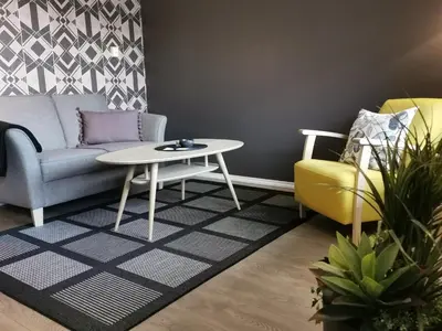 a living room with a couch and a table and chairs at Flåm Marina in Flåm