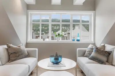 a living room with two couches and a window at Fosswinckel Apartments in Bergen