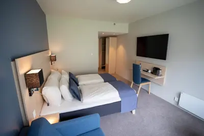 a hotel room with a bed and a tv at Lærdal Hotel in Lærdalsøyri