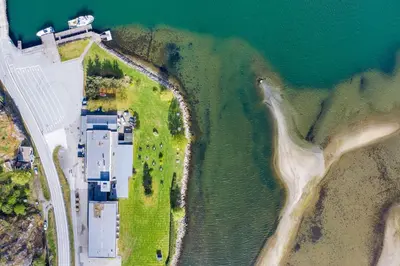 an aerial view of a building next to the water at Lærdal Hotel in Lærdalsøyri