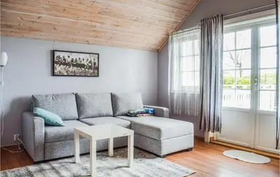 a living room with a couch and a table at Lovely Home In Valevåg With Wifi in Valevåg