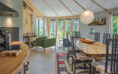 a kitchen and dining room with a wooden table at Lovely Home In Hemsedal With Sauna in Hemsedal