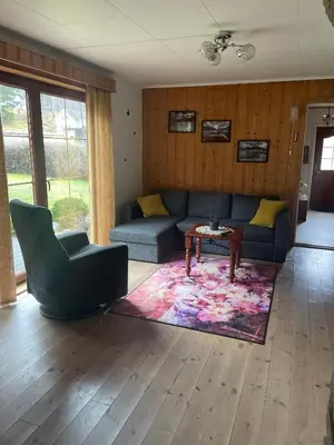 a living room with a couch and a table at Apartment AliS in Tønjum
