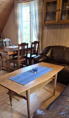 a living room with a coffee table and a couch at Rugsund Handelsstad in Rugsund
