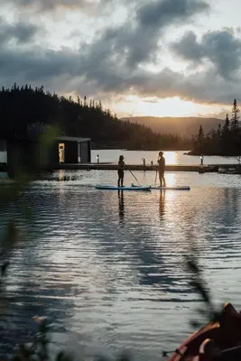 two people are on a paddle board in the water at Gaustablikk Fjellresort in Gaustablikk