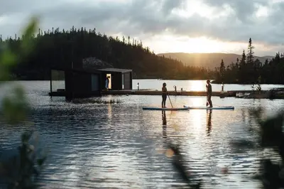 a group of people on paddle boards in the water at Gaustablikk Fjellresort in Gaustablikk