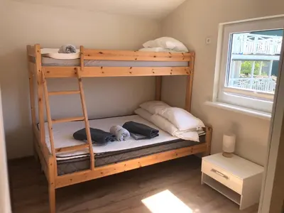 a bunk bed with a dog laying on the bottom bunk at Jølster Holiday home in Skei