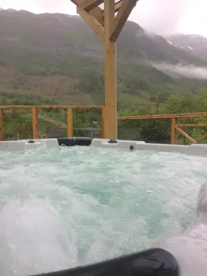 a hot tub with a view of a mountain at Jølster Holiday home in Skei