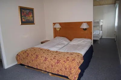 a bedroom with a bed with a wooden head board at Rødberg Hotel in Rødberg