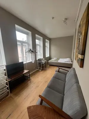 a living room with a couch and a bed at MB Apartments in Bergen