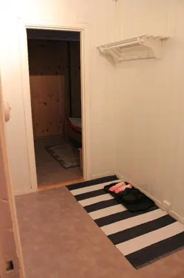 a hallway with a room with a closet and a rug at Leilighet i Åmotsdal in Åmotsdal