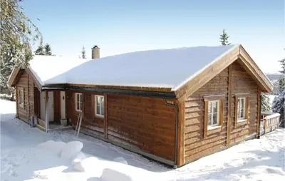 a log cabin with snow on the roof at Sjusjøen Pihl 185 in Sjusjøen