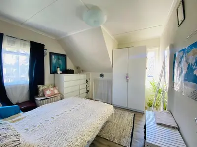 a bedroom with a white bed and a window at Bed and breakfast in Sauda