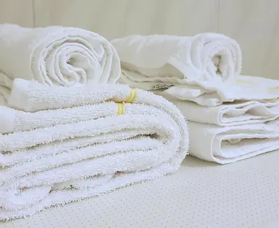 a stack of white towels sitting on a table at Blåtind Apartments in Stordal