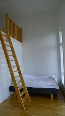 a bedroom with a bunk bed and a ladder at Hordatun Hotel in Røldal