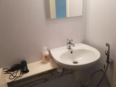 a bathroom with a white sink and a mirror at Family Room in Modern House in Eide