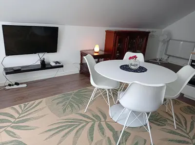 a living room with a white table and chairs at Family Room in Modern House in Eide