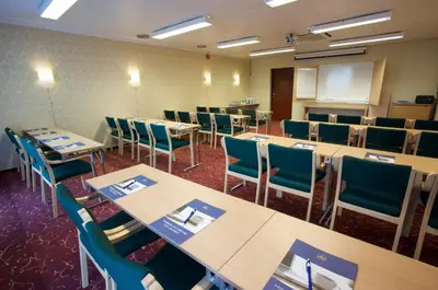 a conference room with tables and chairs and a whiteboard at Best Western Laegreid Hotell in Sogndal