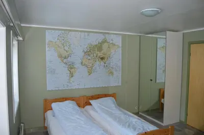 a room with a bed with a map on the wall at Villa Åndalsnes in Åndalsnes