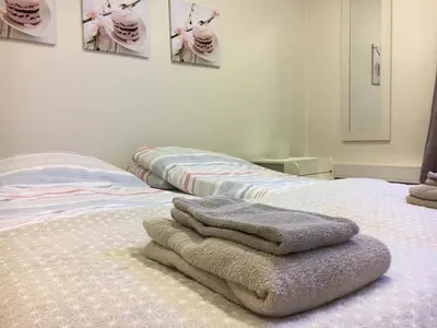 a bedroom with two beds with towels on them at Kirkegata 4 in Ålesund