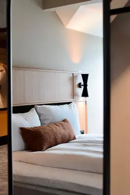 a reflection of a bed in a mirror at Quality Hotel Ålesund in Ålesund