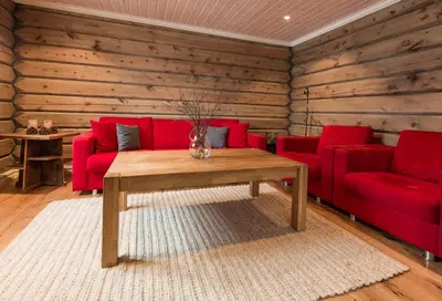 a living room with a red couch and a table at Lake View Apartment 4 bedrooms in Brunstad