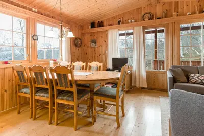a dining room with a wooden table and chairs at Sjåfram in Stranda
