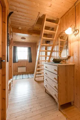 a log cabin with a spiral staircase in a room at Sjåfram in Stranda