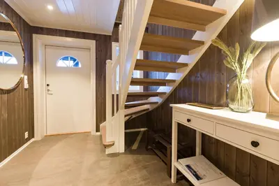 a staircase in a home with wood paneling at Strandafjellet Mountain Lodge in Stranda