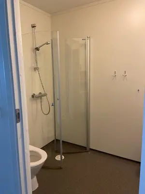 a bathroom with a toilet and a shower stall at Moldefjord Hostel in Molde