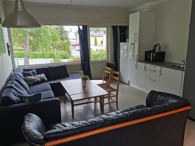 a living room with a couch and a table at Moldefjord Hostel in Molde
