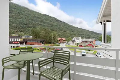 two chairs and a table on a balcony with a view at Kinsarvik Fjordhotel, BW Signature Collection in Kinsarvik