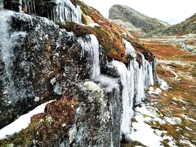 a painting of a waterfall on a mountain at Koselig Hytte i Hemsedal with outdoor Sauna in Hemsedal