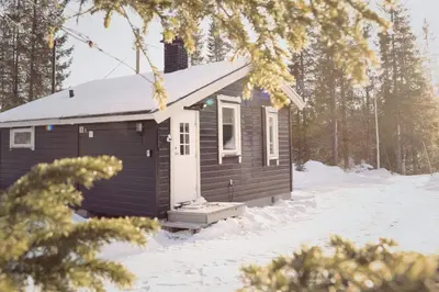 a small cabin in the snow in the woods at Koselig Hytte i Hemsedal with outdoor Sauna in Hemsedal