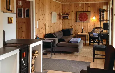 a living room with a couch and a table at Stunning Home In Seim With Wifi in Seim