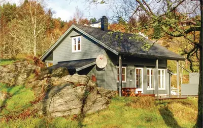 a small house in the middle of a field at Stunning Home In Seim With Wifi in Seim