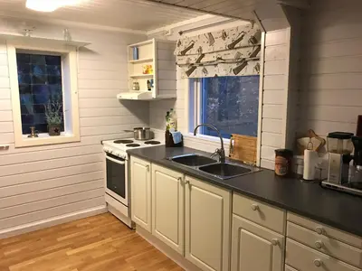 a kitchen with a sink and a stove at Lodge Visnes Stryn in Stryn