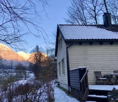 a building with snow on the side of it at Lodge Visnes Stryn in Stryn