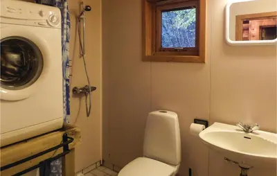 a small bathroom with a toilet and a sink at Gorgeous Home In Vallavik With Wifi in Vangsbygd