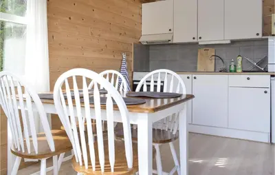 a kitchen with a table with four chairs around it at Gorgeous Home In Vallavik With Wifi in Vangsbygd