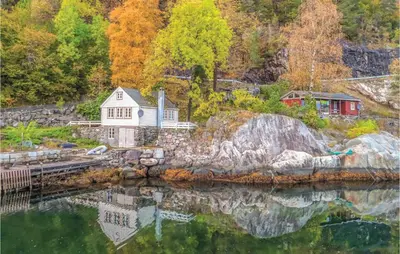 a house on the shore of a body of water at 2 Bedroom Cozy Home In Vallavik in Vangsbygd