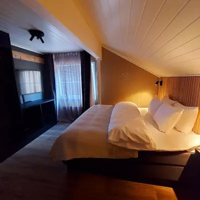 a bedroom with a large bed in a room at Hovdestøylen in Hovden
