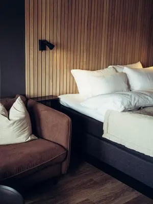 a bed and a chair in a room at Hovdestøylen in Hovden