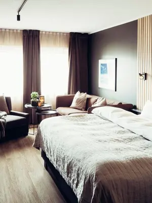 a bedroom with a large bed and a couch at Hovdestøylen in Hovden