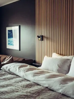 a bedroom with a large bed with white sheets at Hovdestøylen in Hovden
