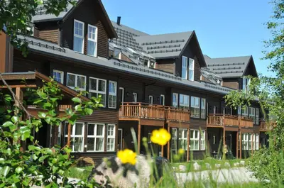 a large wooden building with white windows and balconies at Hovdestøylen in Hovden