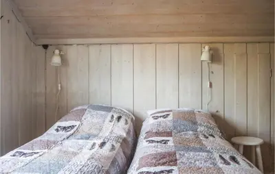 a bedroom with two beds with quilts at Three-Bedroom Holiday Home In Sjusjoen in Sjusjøen